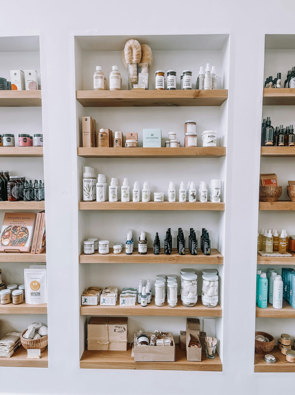 A shelf displaying a variety of products, including bottles, boxes, and containers in an organized arrangement.